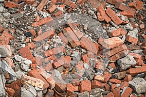 Background with a pile of old red bricks, shards of concrete and rebar