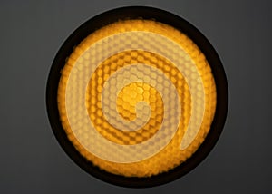 Background of pilot pulsed studio light with a honeycomb grid and diffuse film