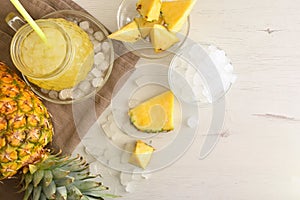 Background with pineapple drink with ice on table top view