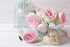 Background with pink roses flowers in blue vase and decorative