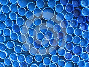 Background of plastic colorful bottle caps. Contamination with plastic waste. Environment and ecological balance. Art from junk.