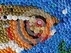 Background of plastic colorful bottle caps. Contamination with plastic waste. Environment and ecological balance. Art from junk.