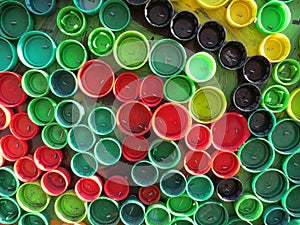 Background of plastic colorful bottle caps. Contamination with plastic waste. Environment and ecological balance. Art from junk.