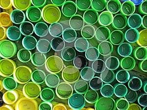 Background of plastic colorful bottle caps. Contamination with plastic waste. Environment and ecological balance. Art from junk.