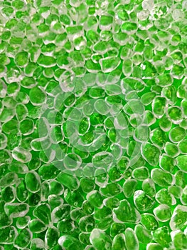 Background of polished quartz stones and rocks on a green background as a background and backdrop