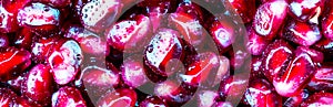 Background of pomegranate berries. Water droplets on a grenade