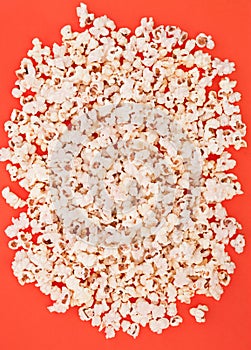 Background. Popcorn on a bright red background, top view. Flat lay. Copyspace