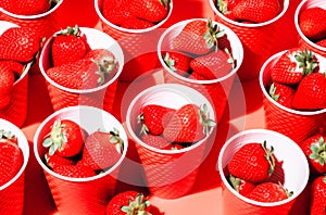 background portioned strawberries in cups