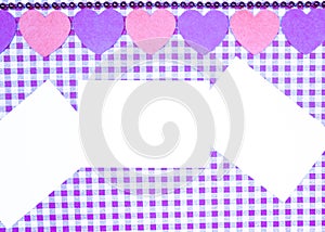 Background with purple and white Vichy fabric for Valentine`s day with purple and pink hearts and three white cards to put the