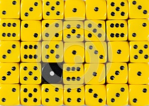 Background of random ordered yellow dices with one black cube