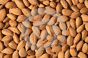 Background of raw almonds for background or textures. Unshelled almonds in shell