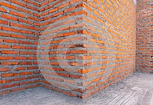 Background red brick wall under construction site