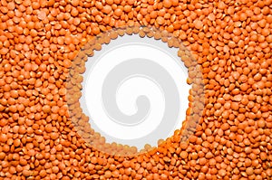 Background from red lentils masoor dal with round free space for inscriptions in center
