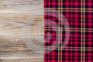 background of red plaid and wooden boards. Top view with copyspace