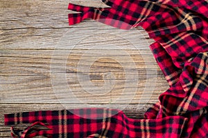 background of red plaid and wooden boards. Top view with copyspace