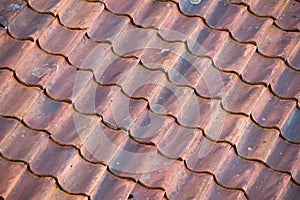 Background of red roof made of old tiles. In diagonal composition