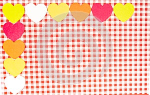 background with red and white Vichy fabric for Valentine\'s Day with pink  orange  yellow and white hearts. v