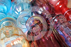 Background of ribbed colored glass flasks. coloured decorative glass