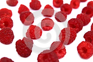 Background of ripe red raspberries on a white background.