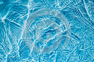 Background of rippled pattern of clean water in a blue swimming
