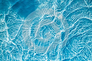 Background of rippled pattern of clean water in a blue swimming