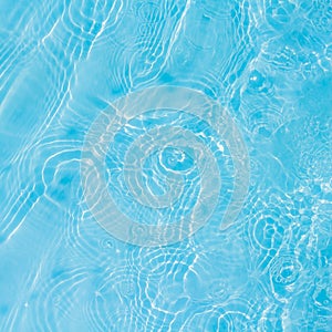 Background of rippled pattern of clean water in a blue swimming