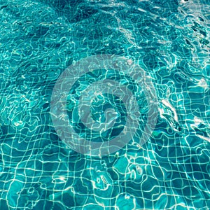 Background of rippled pattern of clean water in a blue swimming