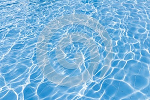 Background of rippled pattern of clean water in a blue swimming