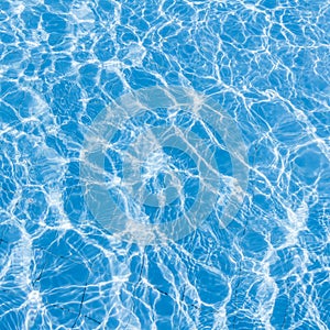 Background of rippled pattern of clean water in a blue swimming