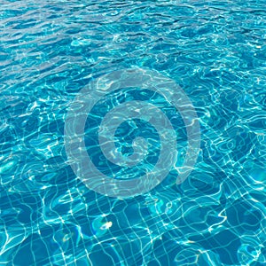 Background of rippled pattern of clean water in a blue swimming