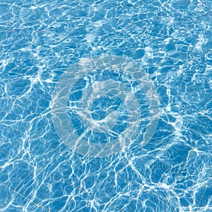 Background of rippled pattern of clean water in a blue swimming