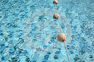 Background of rippled pattern of clean water in a blue swimming pool