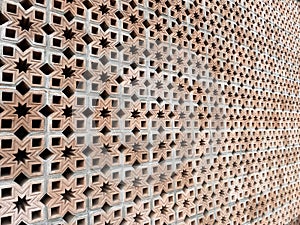 The background of the roster wall has an Islamic art motif