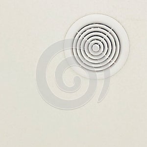 Background with round white vent hole in the ceiling