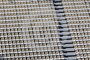 Background of row of chairs in an open air theater as pattern an symbol for organization