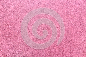 Background of rubberized coating used in children`s and sports grounds pink. Backgrounds