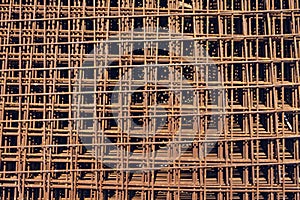 Background with rusty metal armature net for building construction