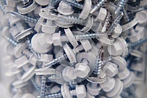 Background of the screws made of light metal with plastic, close-up