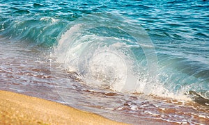 Background with sea wave on sandy beach.