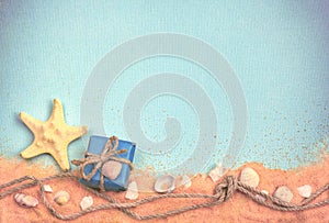 Background with seashells, sand, gift box, rope with knot, empty space for text