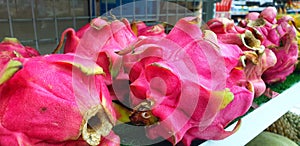 the background of the seller of fresh dragon fruit photo