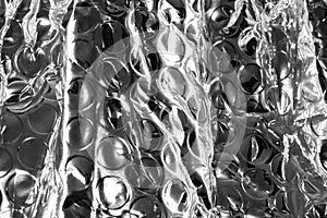 A background of shiny sivery bubble wrap.