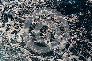 Background shot of aqua sea water surface. Abstract texture of nature. Rapid sea while sailing ship