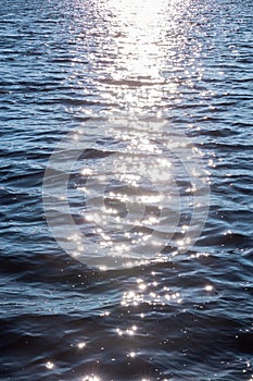 Background shot of sea water surface. glare of the sun on the surface of the water