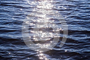 Background shot of sea water surface. glare of the sun on the surface of the water