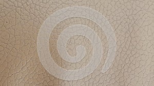 Shiny beige leather background close-up. Beige Glossy Texture Of Artificial Leather.