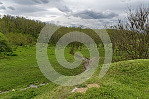Background of sky, clouds, field and river