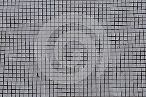 Background of a small old white tile on the building.