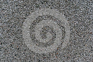 The background. Small stones on the concrete surface