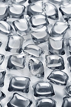 Background of soft capsules filled with detergent.